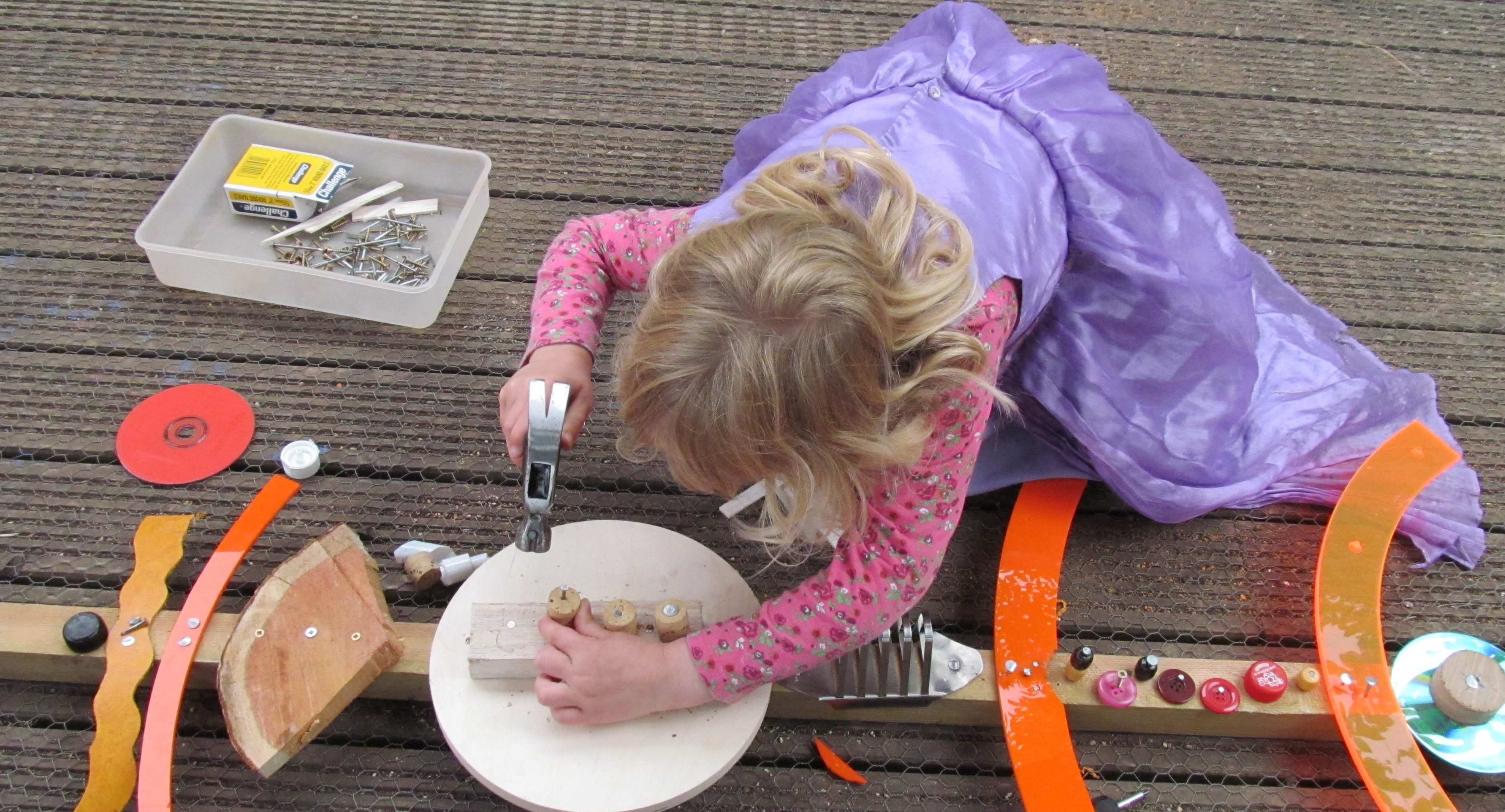 Child using woodworking tools - Irresistible Learning 